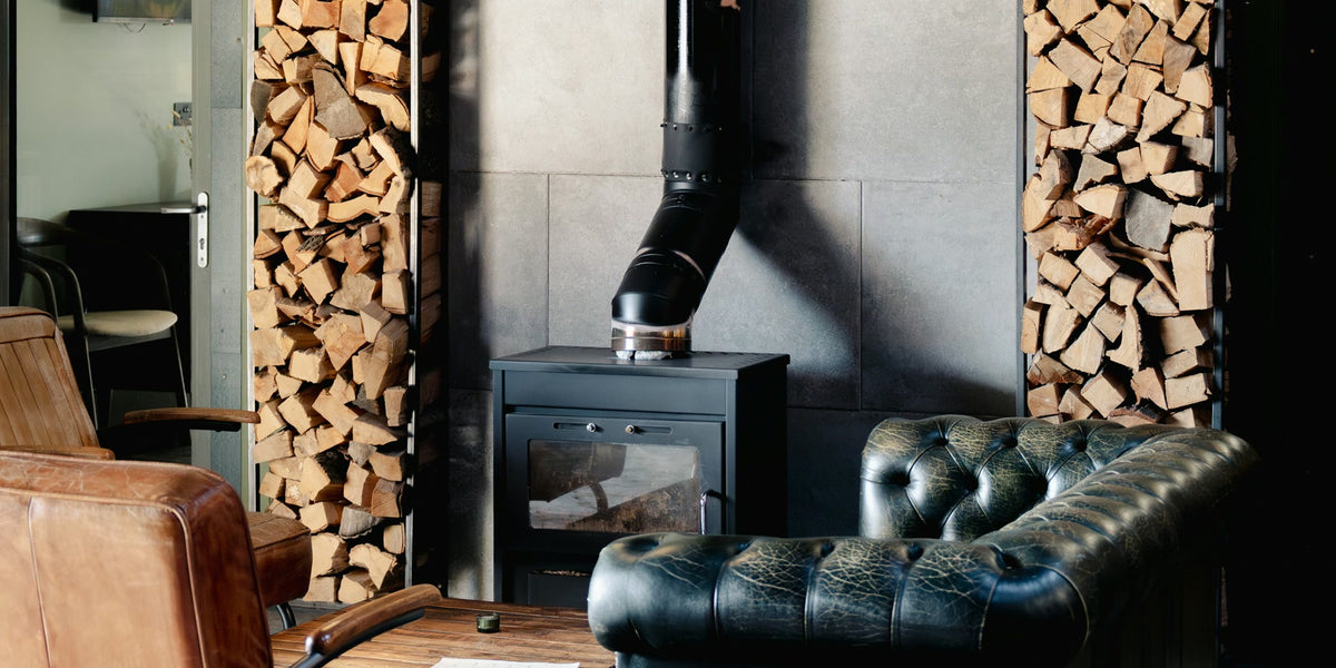 Wood-burning stove with stacked firewood — photo by Toa Heftiba on Unsplash