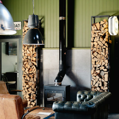 Real wood-burning stove with stacked firewood — photo by Toa Heftiba on Unsplash